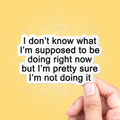 Hand holding a piece of paper with text on a yellow background
