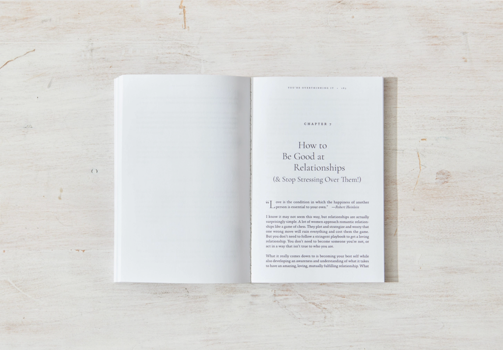 Open book on a wooden surface with text on a white page.
