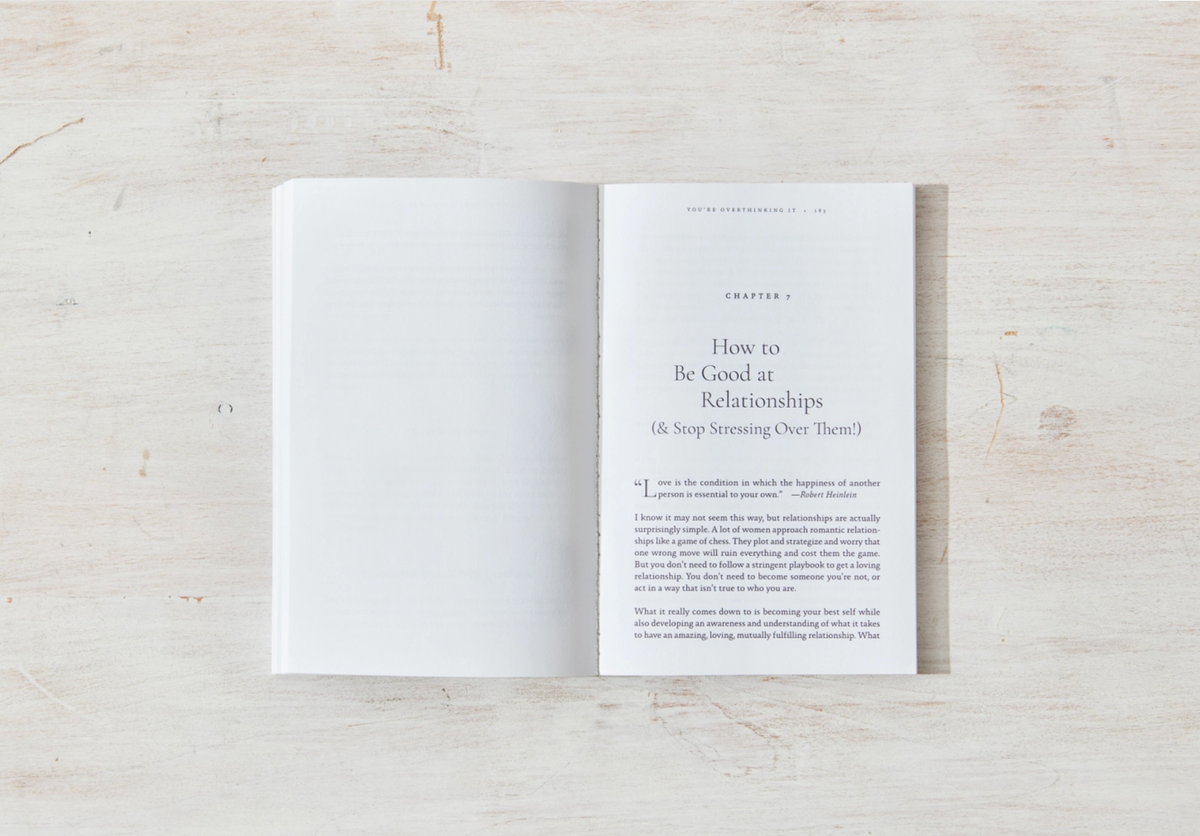 Open book on a wooden surface with text on a white page.