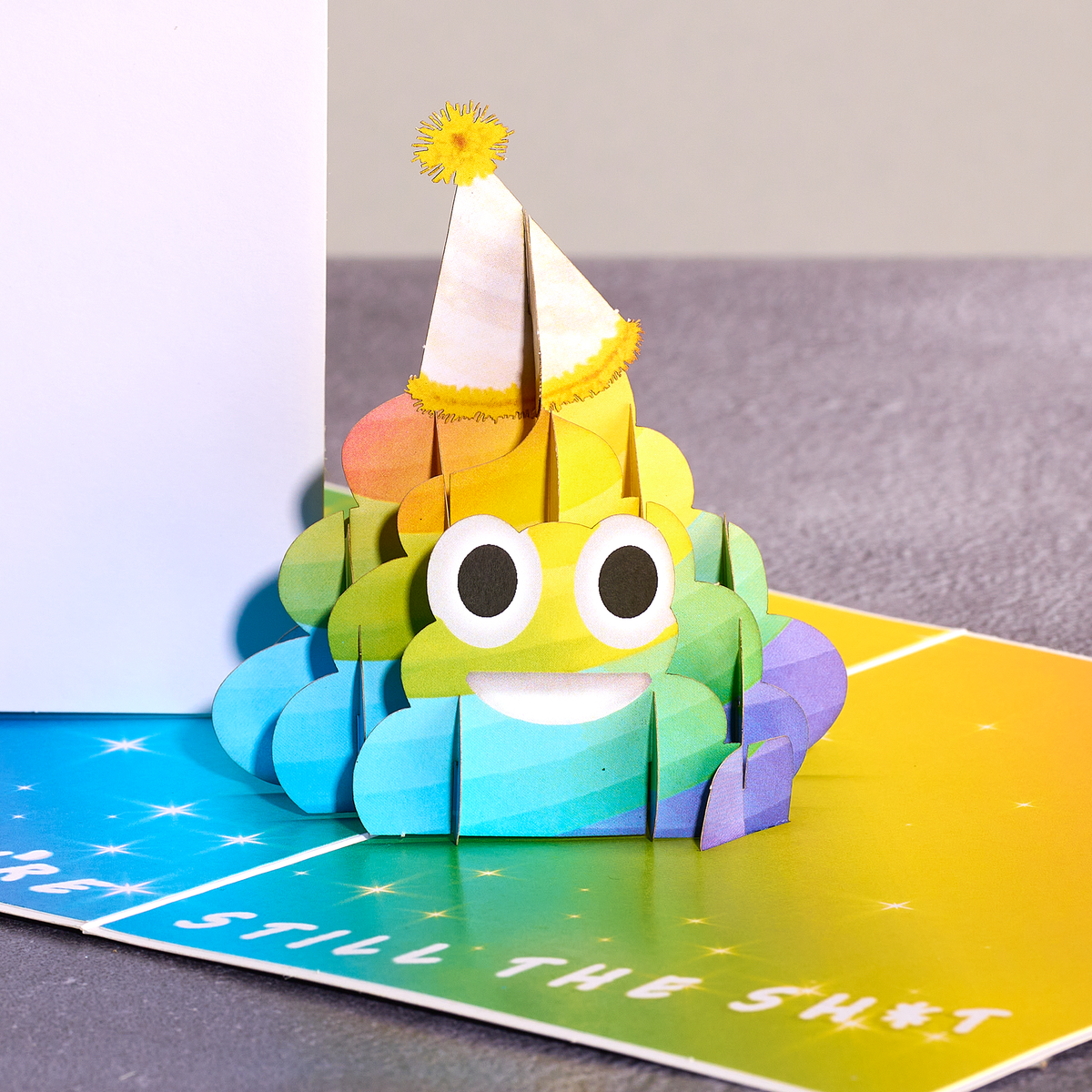 Colorful paper monster with a party hat on a colorful card