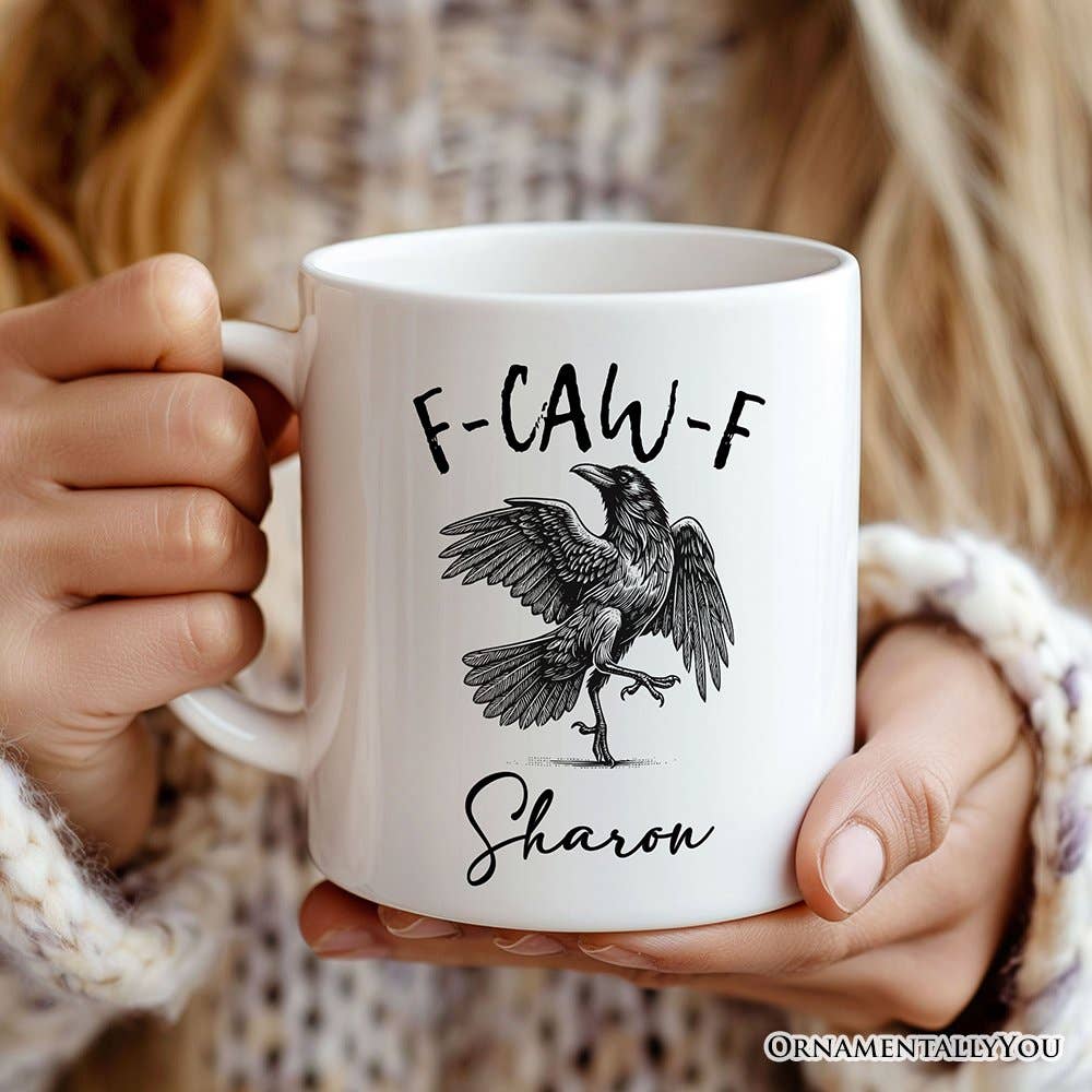 Person holding a white mug with a bird illustration and text