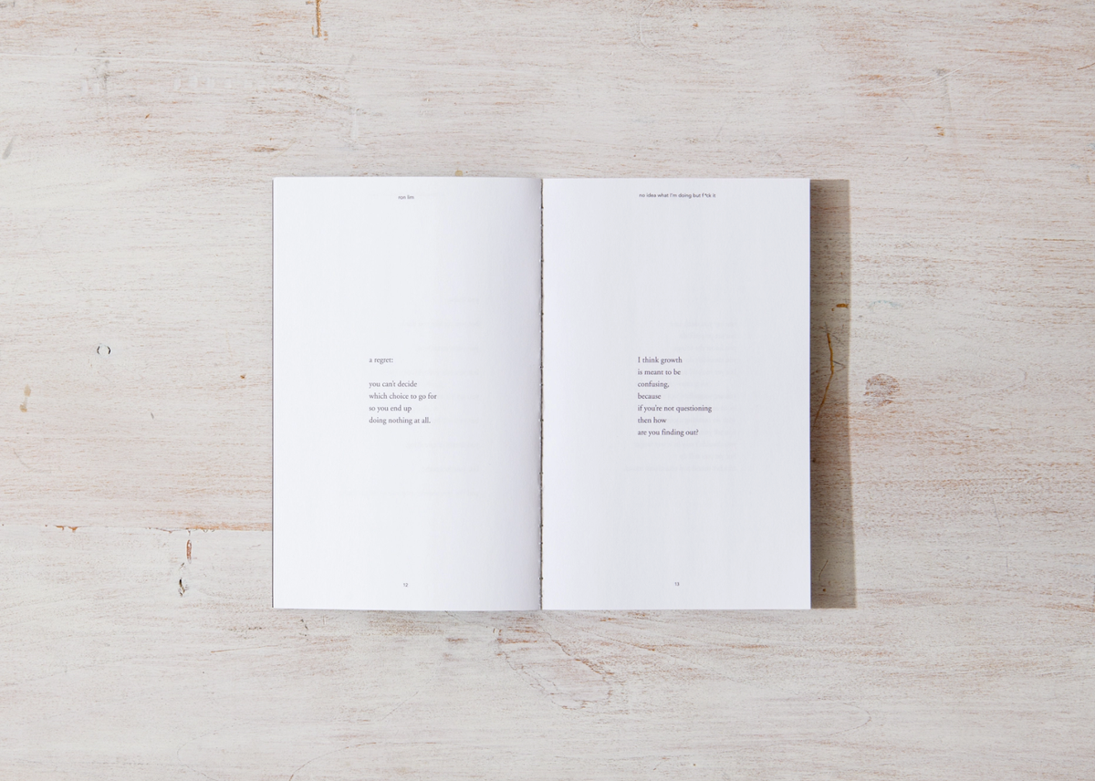 Two white pages with text on a wooden surface