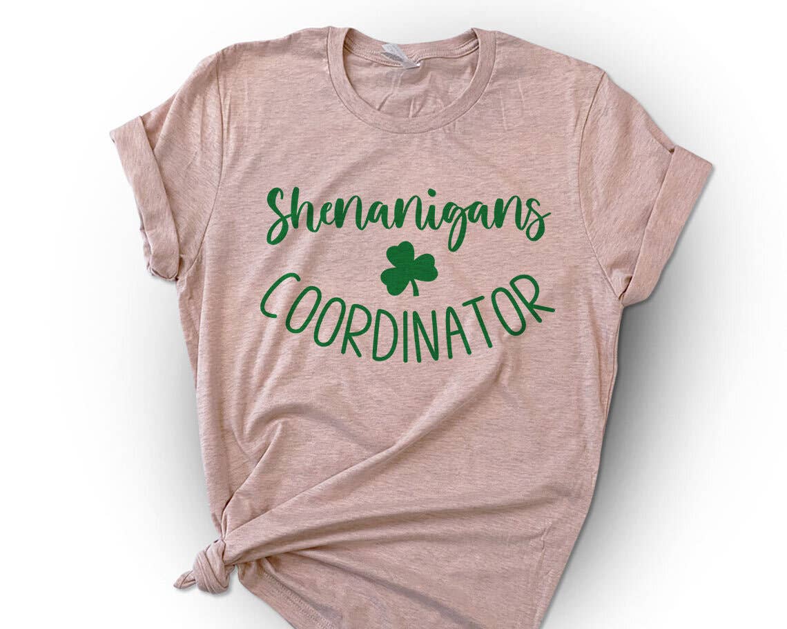 Pink t-shirt with 'Shenanigans Coordinator' text and shamrock on a white background