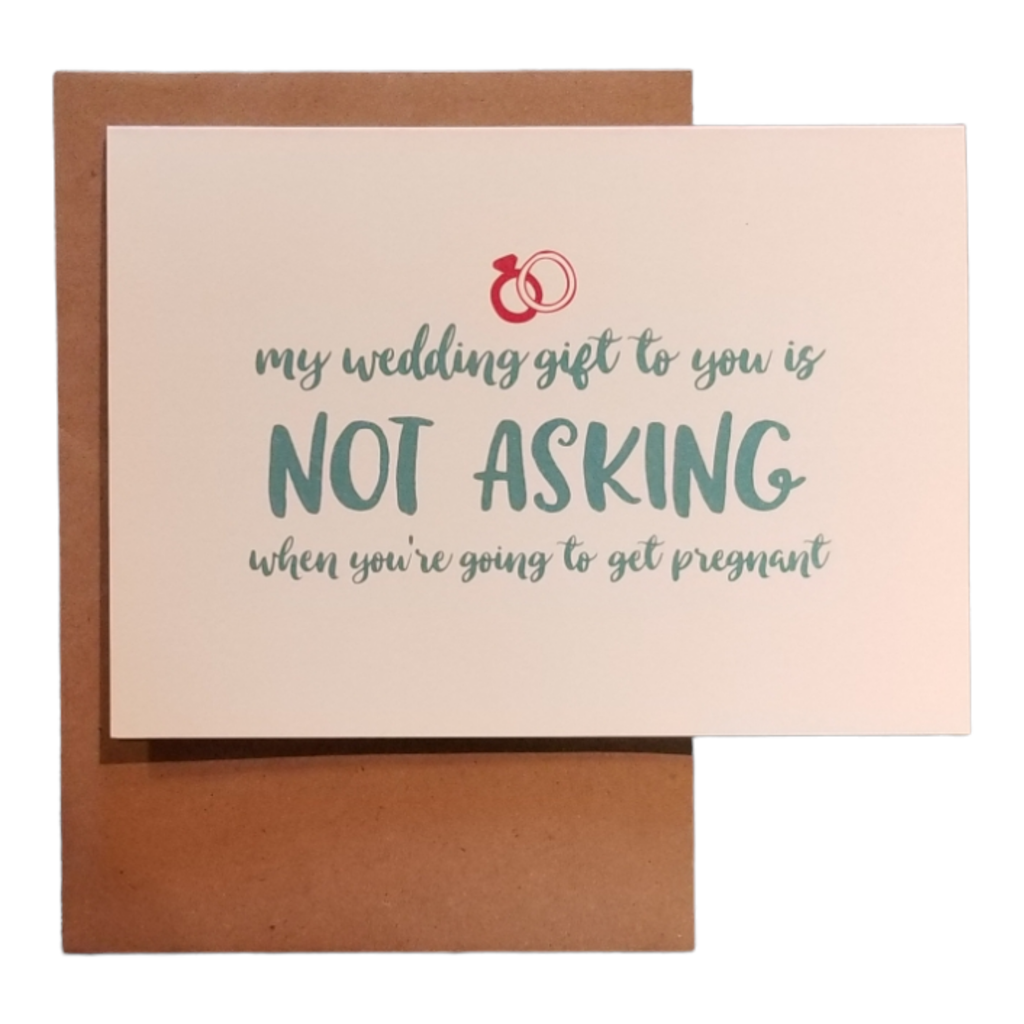 Card with text 'My wedding gift to you is not asking when you're going to get pregnant' on a beige background with a brown envelope.