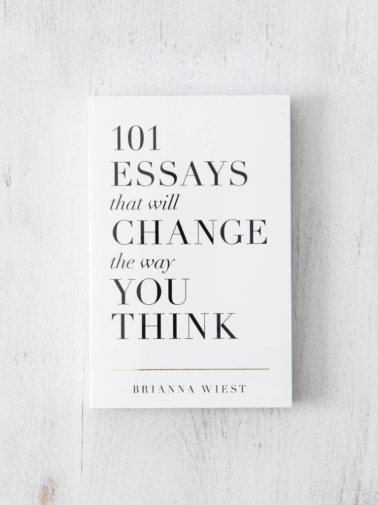 Book titled '101 Essays that will Change the Way You Think' by Brianna Wiest on a light wooden surface.