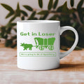 White mug with 'Generation X' design held by a person against a blurred background