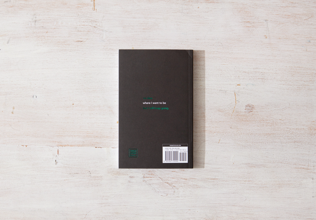 Black book with a barcode on a light wooden surface
