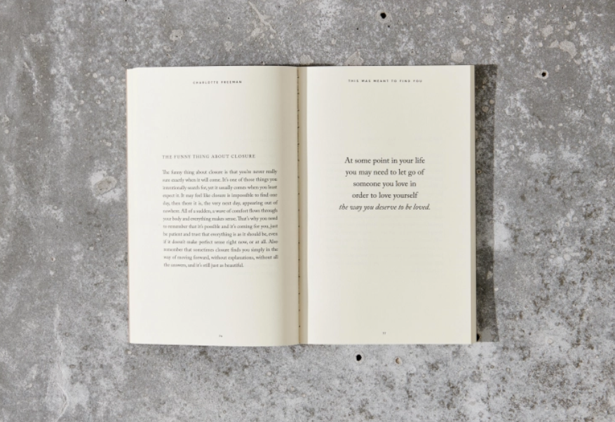 Open book with text on a textured gray surface
