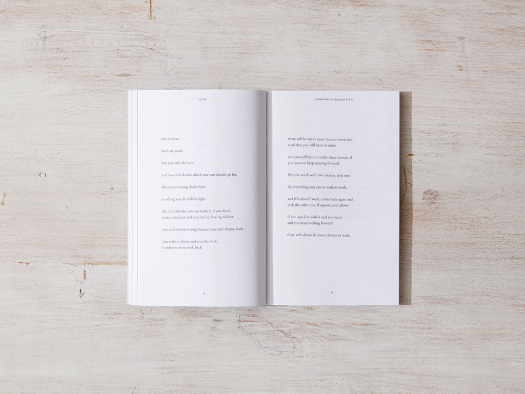 Open book with text on white pages on a light wooden surface