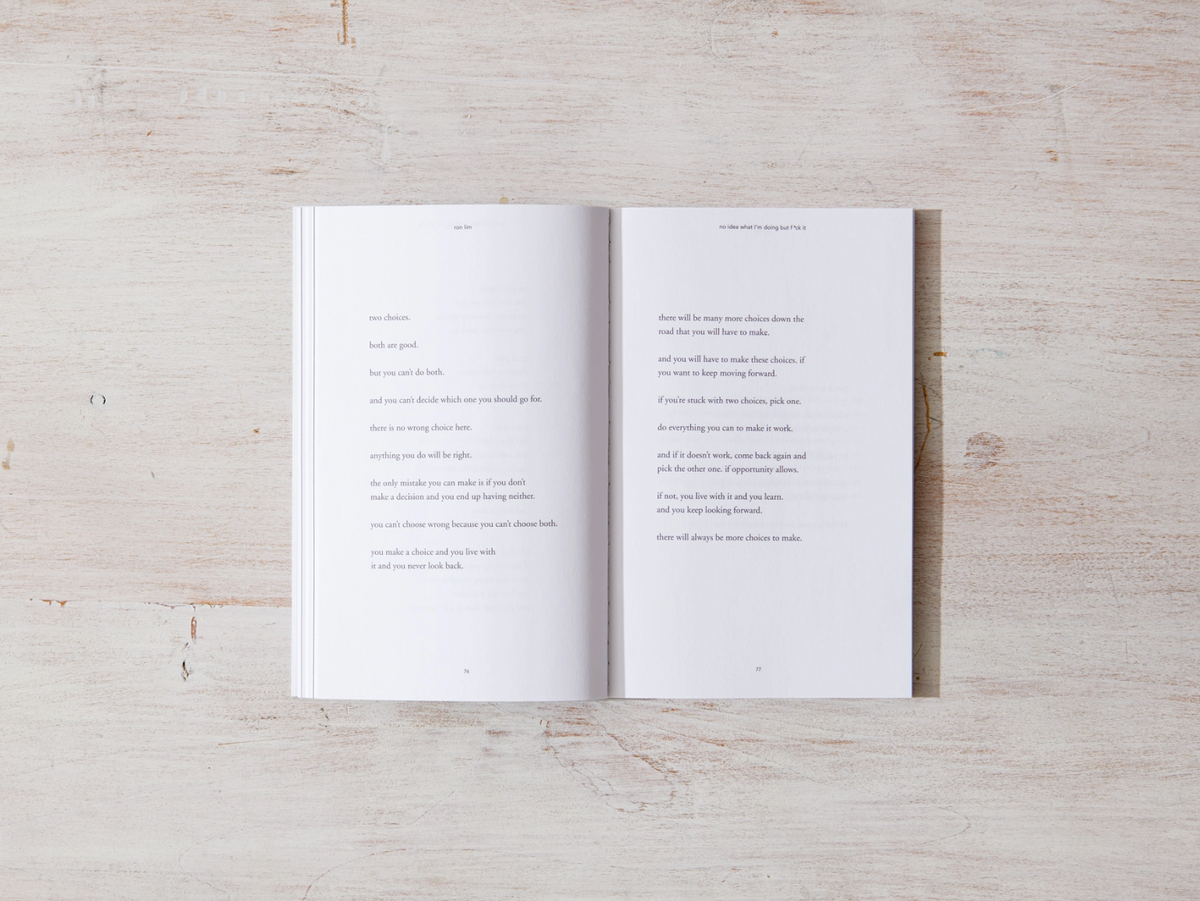 Open book with text on white pages on a light wooden surface