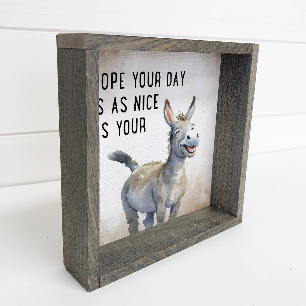 Wooden framed sign with a cartoon donkey and text on a white background