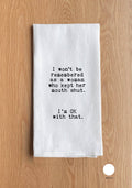 White towel with black text on a wooden surface