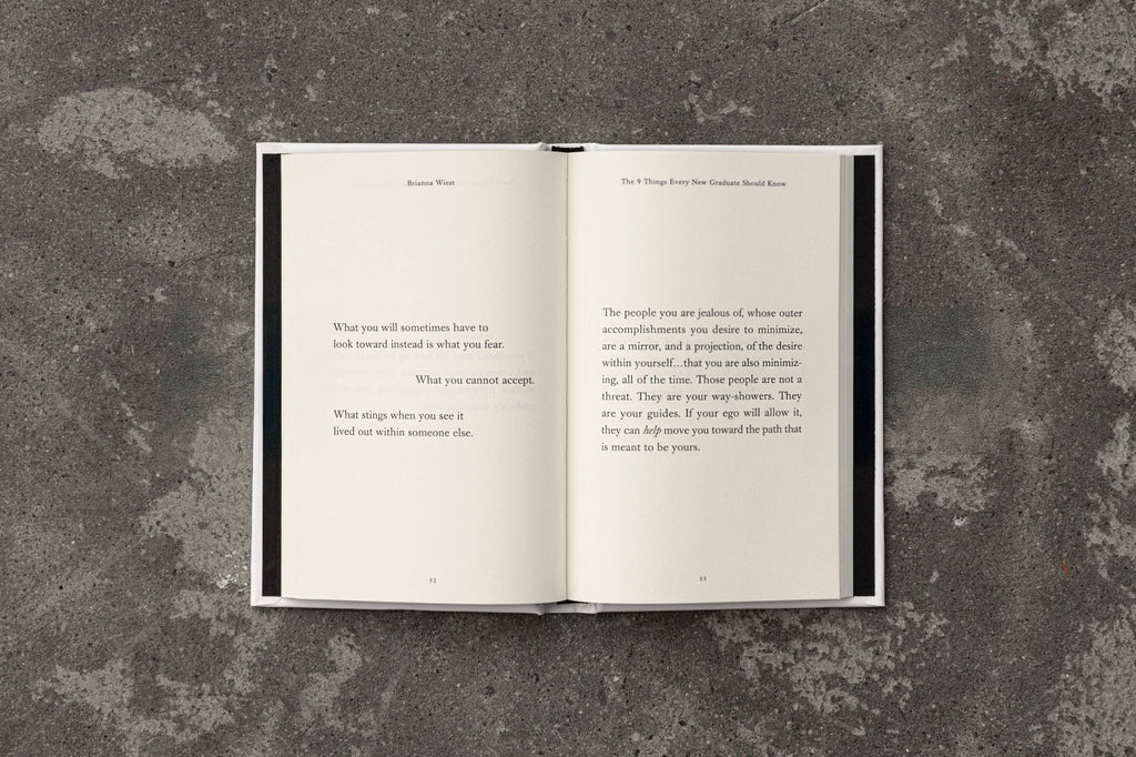 Open book with text on a textured gray surface