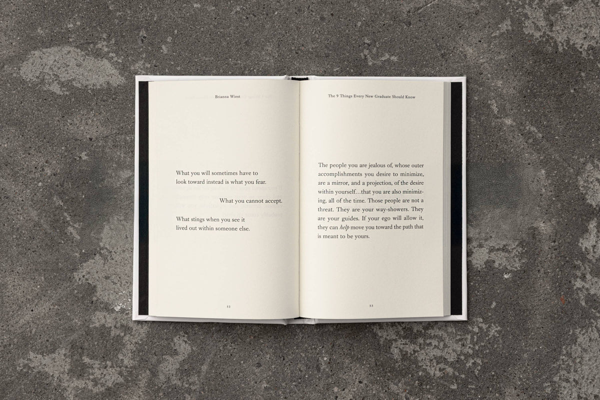 Open book with text on a textured gray surface