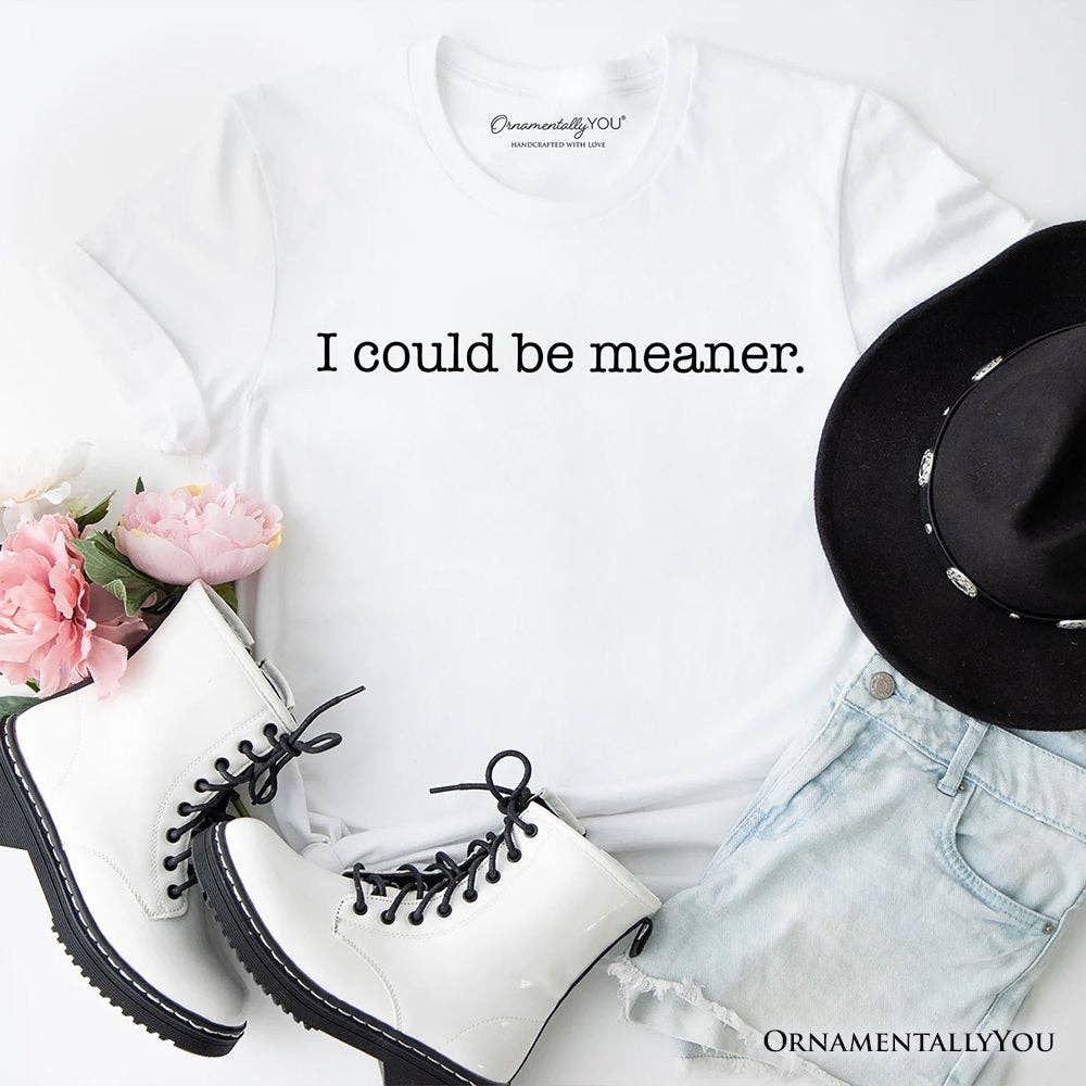 White shirt, black boots, black hat, and pink flowers on a white background with text 'I could be meaner.'