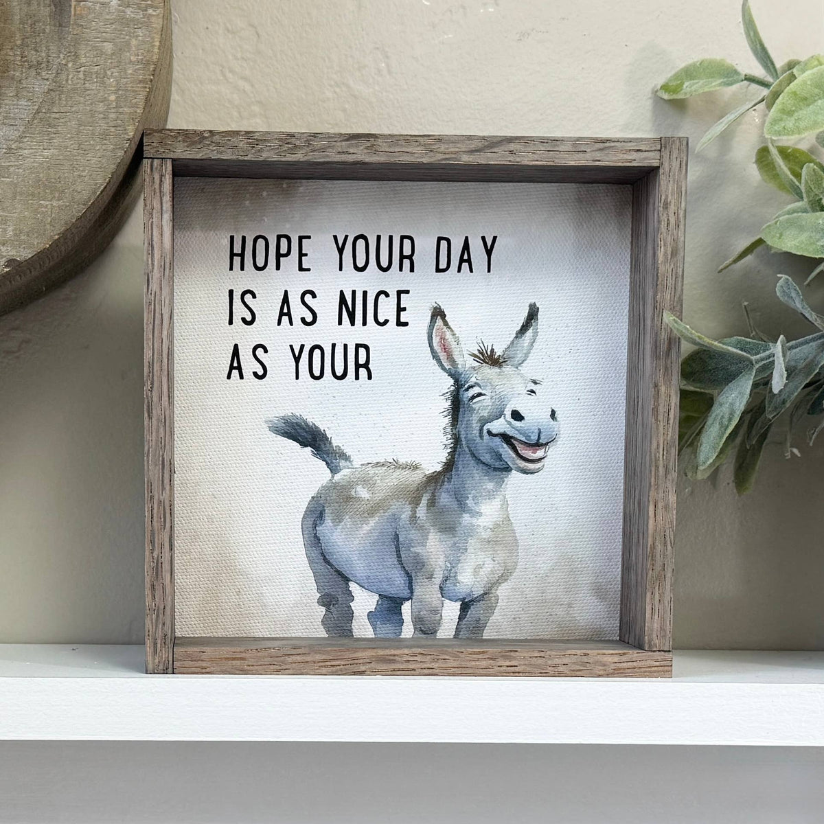 Framed picture with a donkey illustration and text on a neutral background