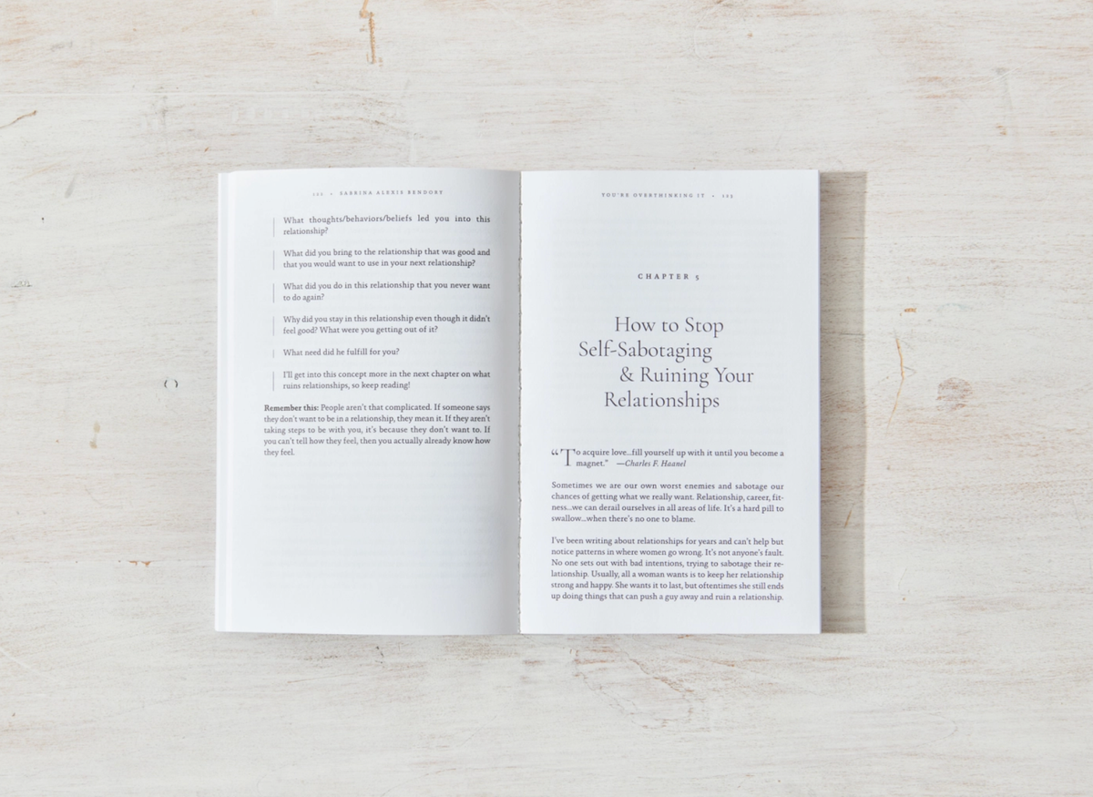 Open book on a light wooden surface with text visible