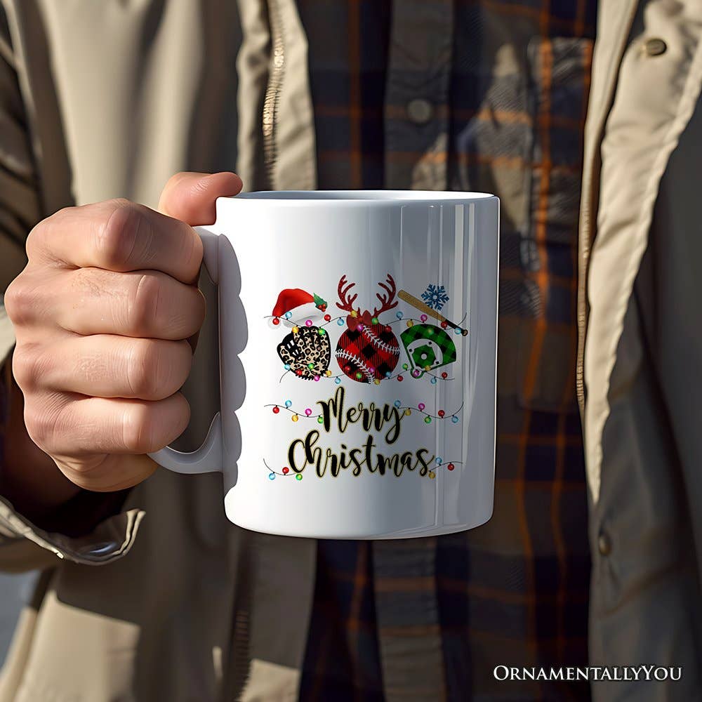 Person holding a white mug with Christmas-themed design and 'Merry Christmas' text.