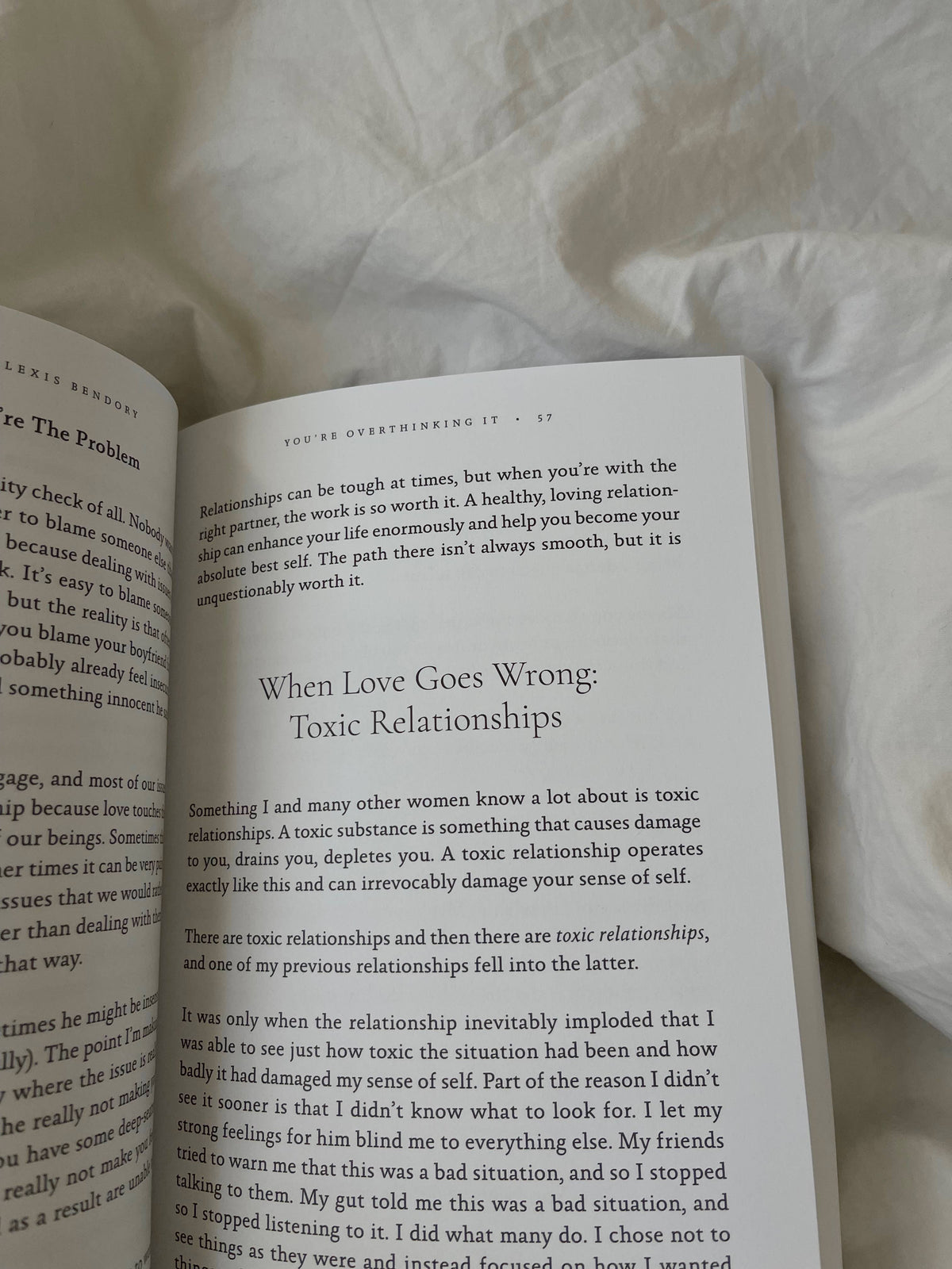 Open book on a textured surface with text visible