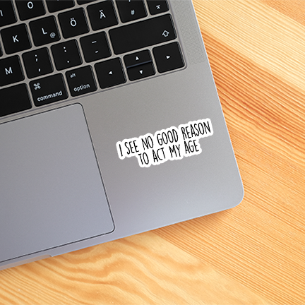Laptop with a sticker on the palm rest area on a wooden surface