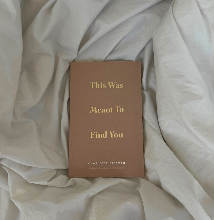 Book titled 'This Was Meant To Find You' by Charlotte Freeman on a soft fabric background