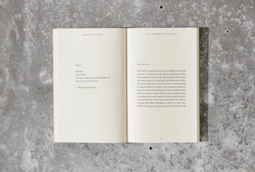 Open book with text on a textured gray surface