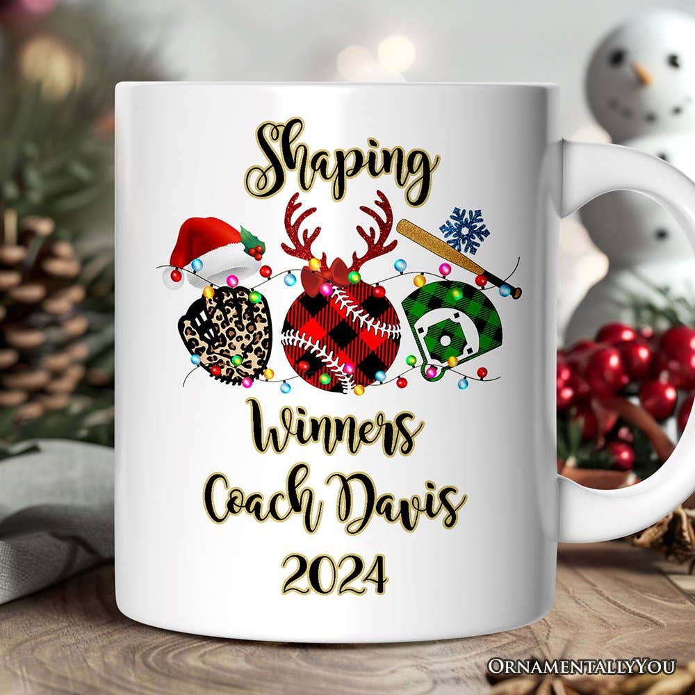 White mug with Christmas-themed design and text on a wooden surface with festive decorations.