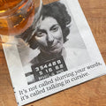 Mugshot of a woman with text on a wooden surface