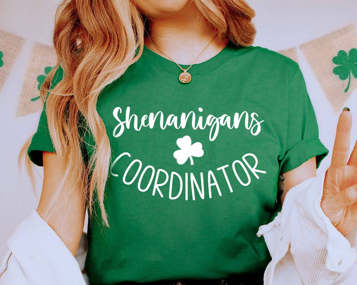 Person wearing a green t-shirt with 'Shenanigans Coordinator' text and shamrock design.