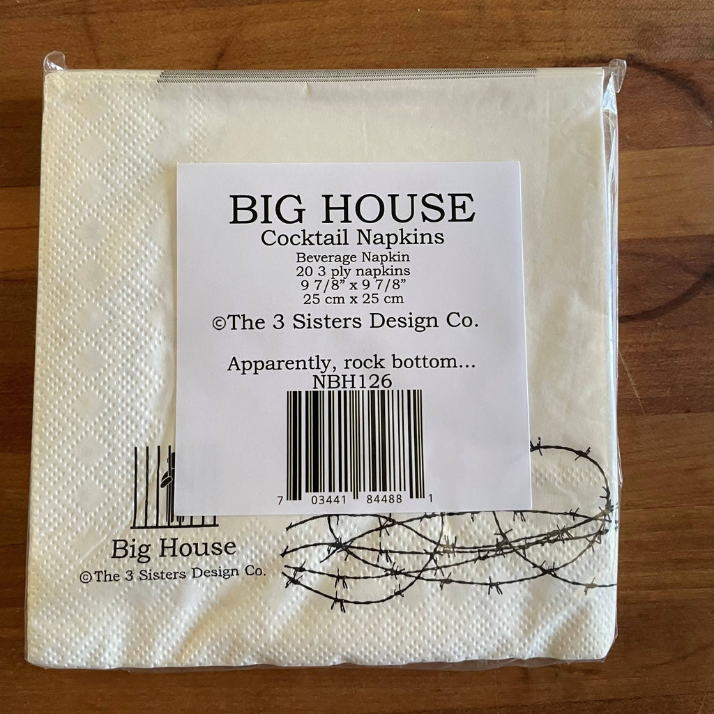 Packaged cocktail napkins with a label on a wooden surface