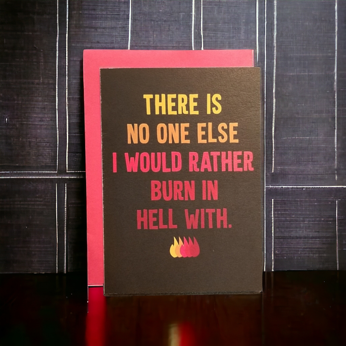 Card with humorous text and flames on a dark background