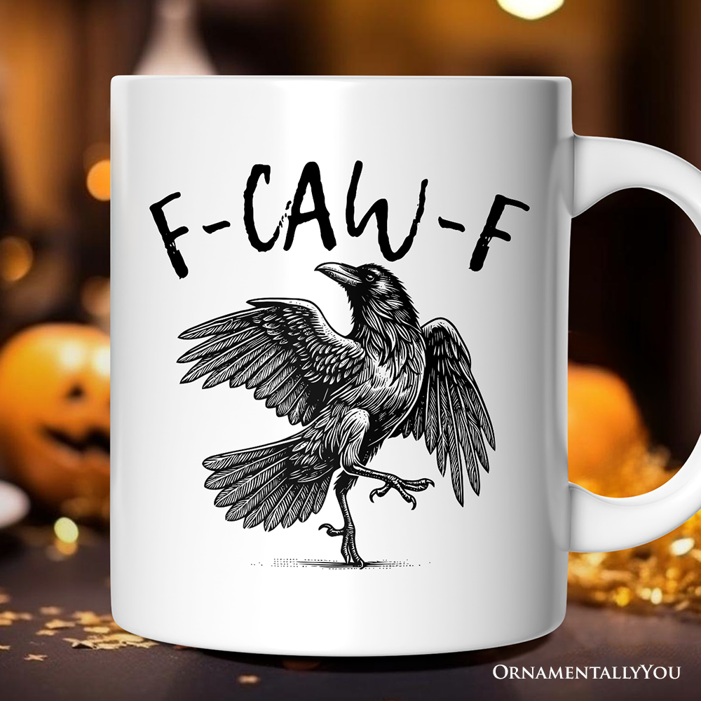 White mug with a black crow illustration and 'F-CAW-F' text on a blurred Halloween-themed background.