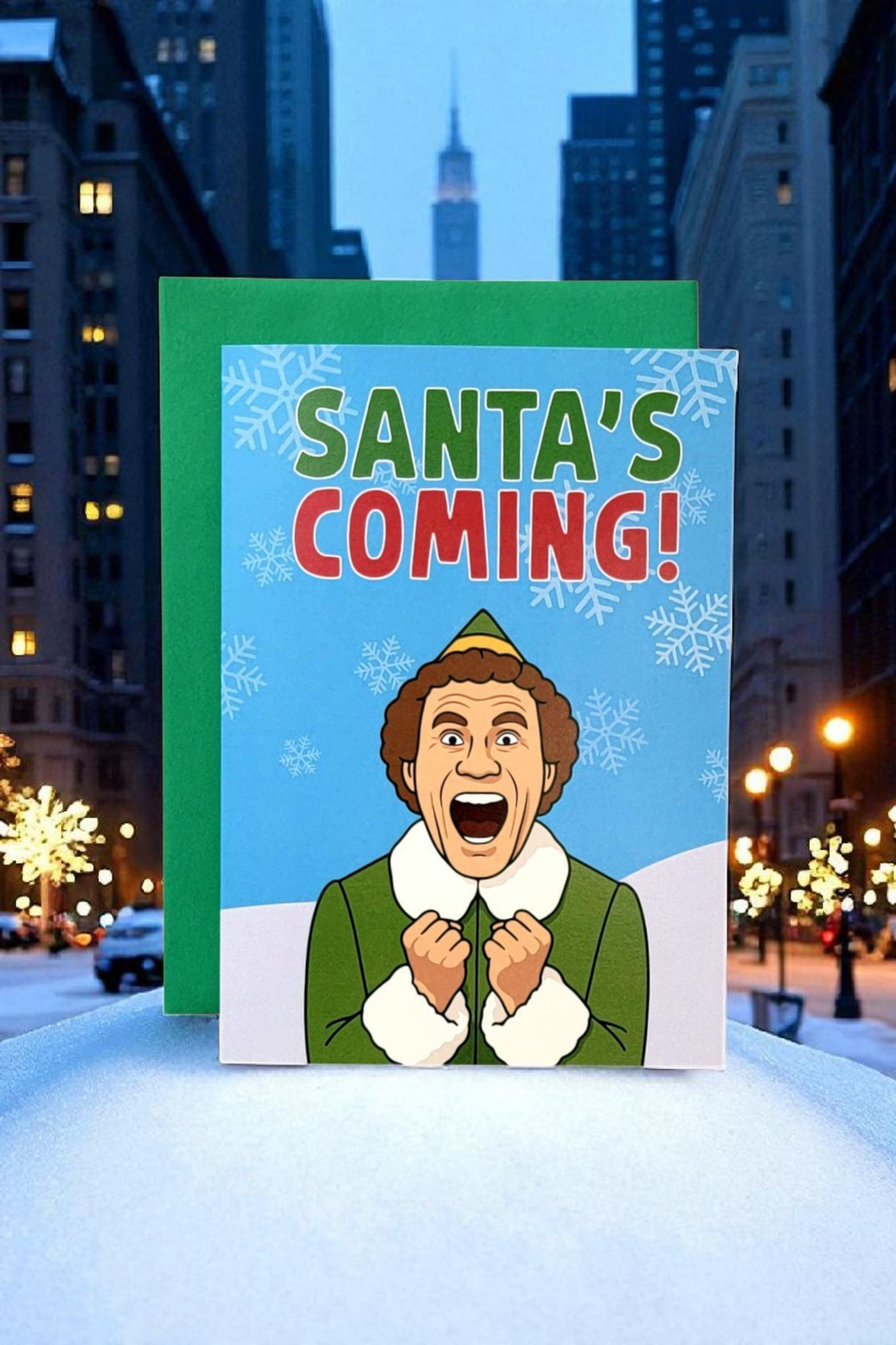 Christmas card with 'Santa's Coming!' text and a character in a snowy cityscape.