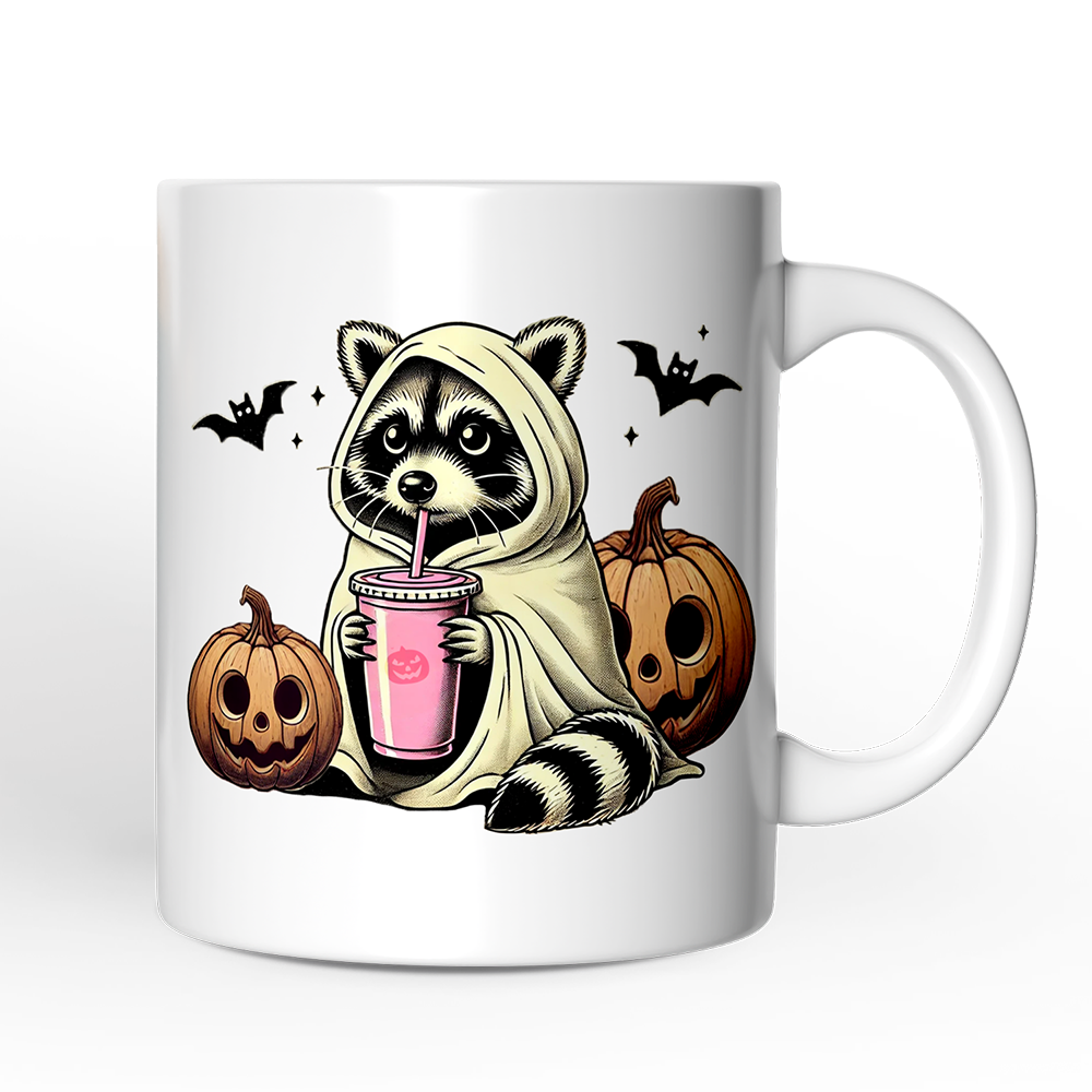 Mug with a raccoon in a hoodie holding a pink drink, surrounded by pumpkins and bats on a white background