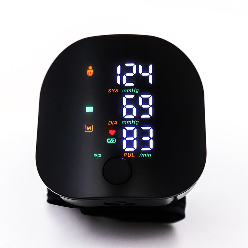 Digital blood pressure monitor with a black casing on a white background
